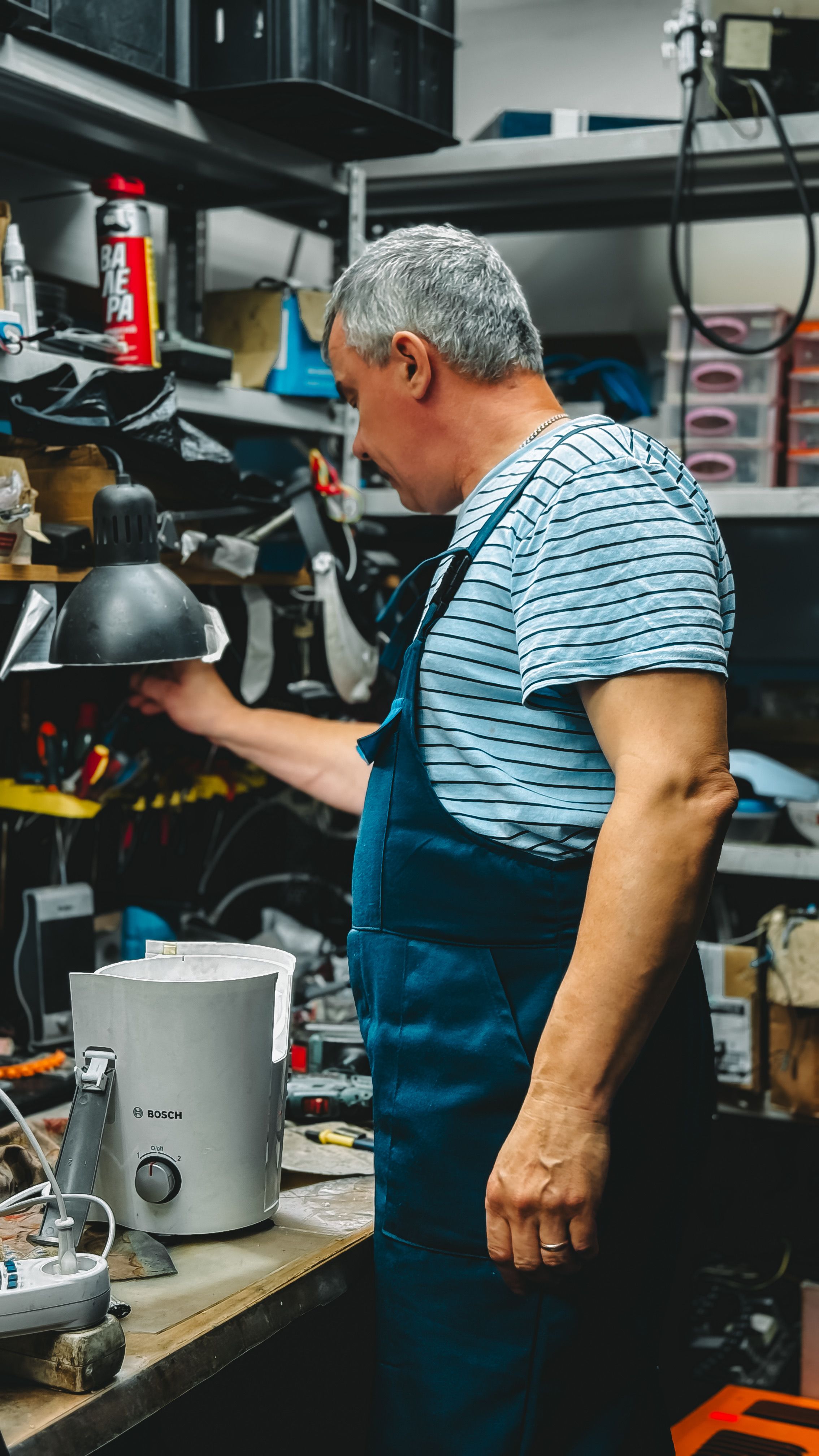 Technician repairing an appliance at the workshop